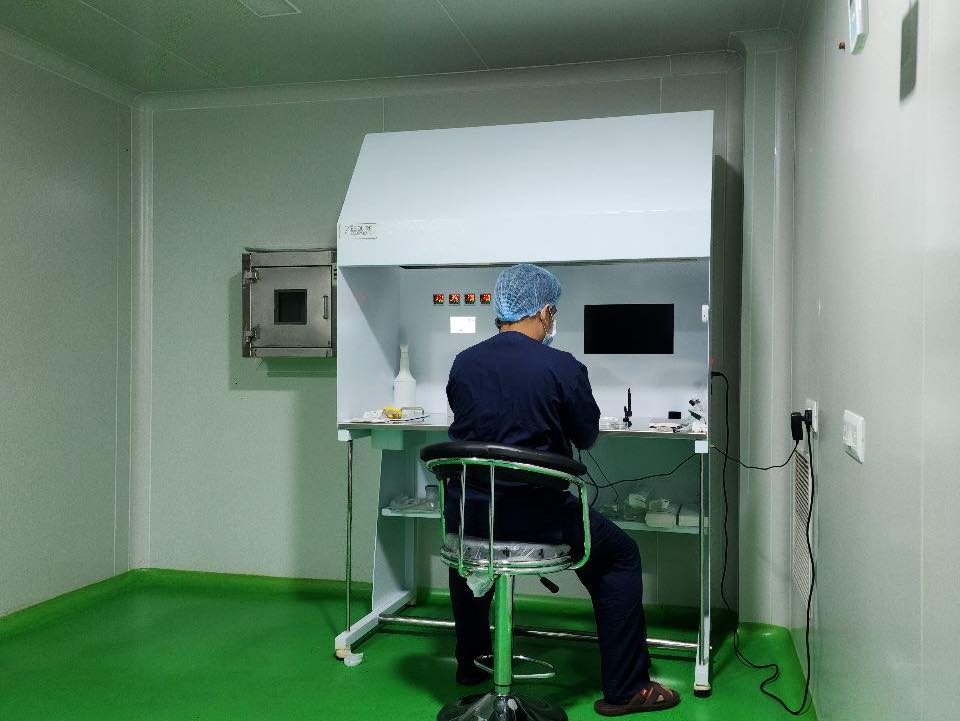 An embryologist working at the micromanipulation bench at Valley Fertility Centre